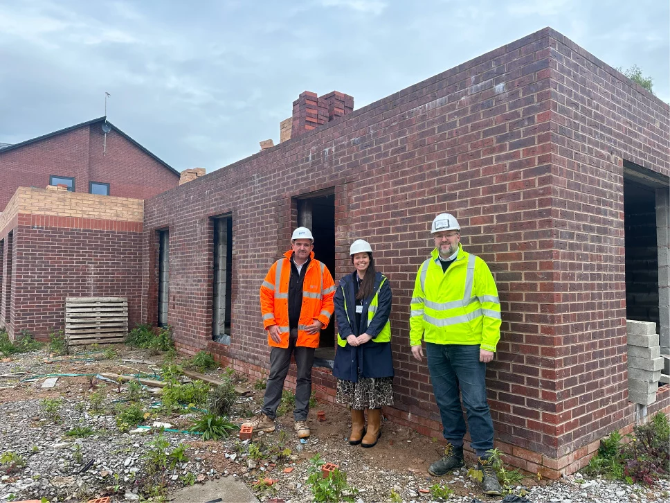 M&Y Staff joined by Weaver Vale Housing Trust in front of a brick building being demolished, the former site of a pub
